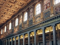 Ornate columns and paintings inside a grand hall