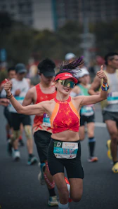 Woman running marathon, giving thumbs up