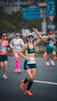 Woman with panda ears running a marathon race.