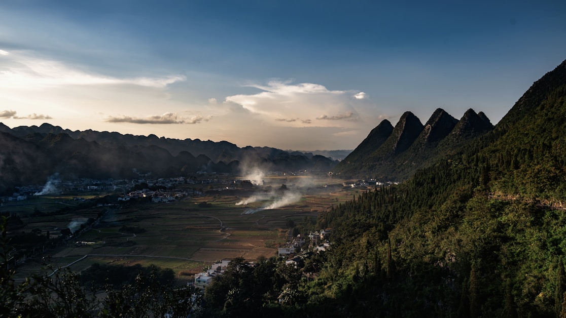hidden villages china - valley with smoking villages and mountains