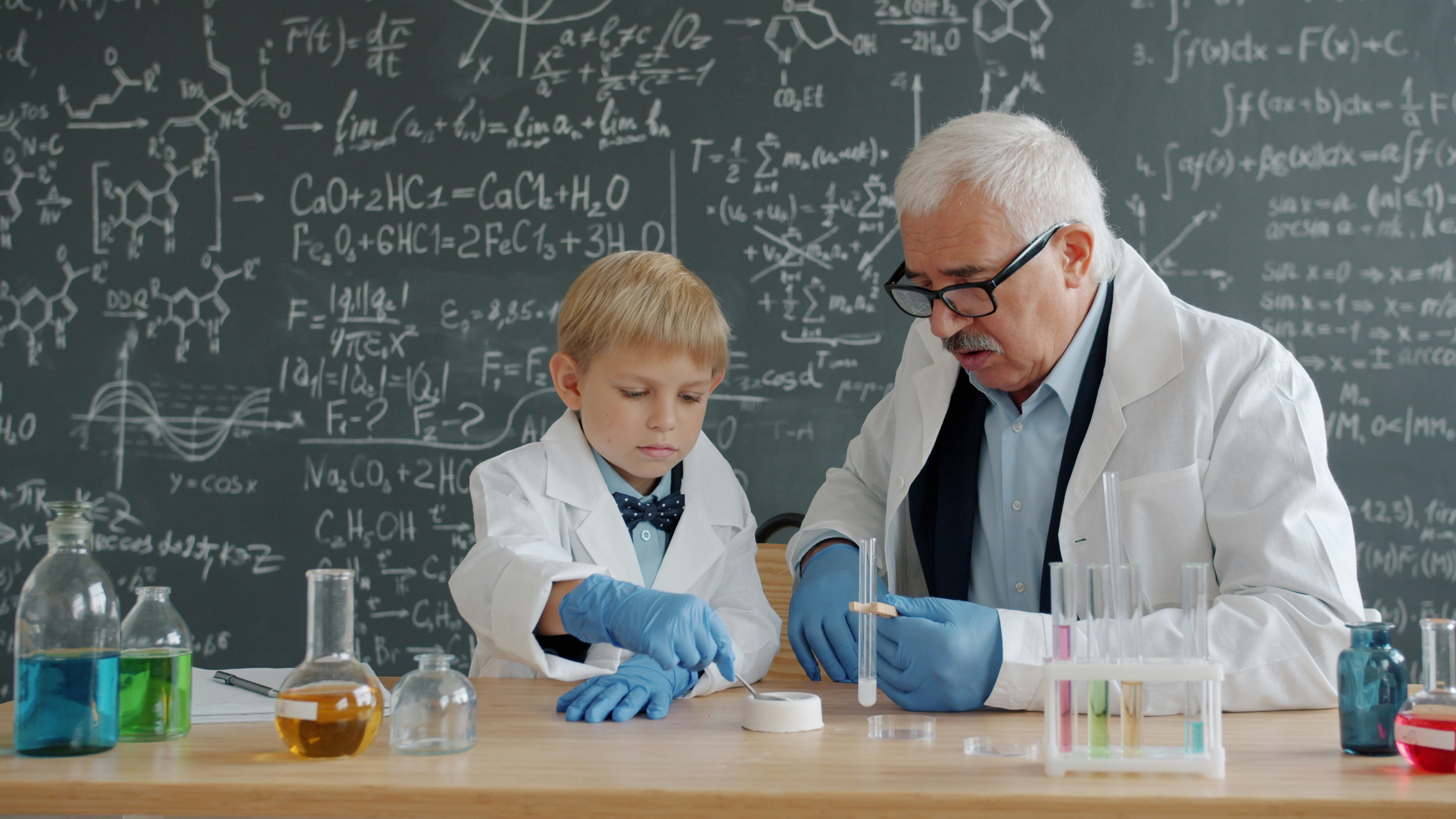 Professor and student conduct science experiment in lab
