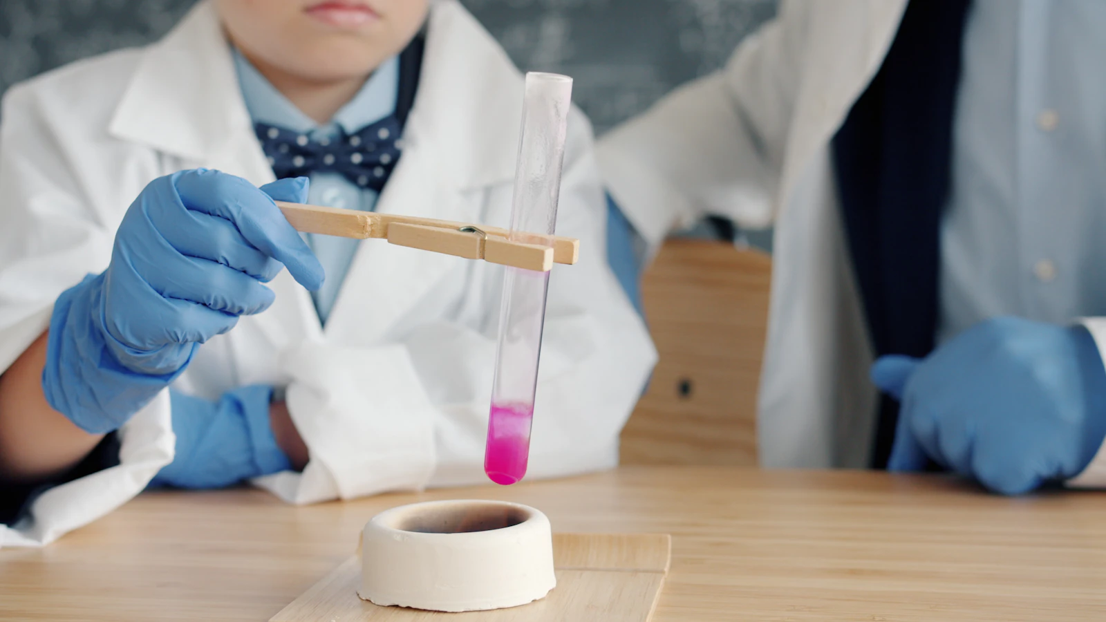 Children in lab coats conducting a science experiment