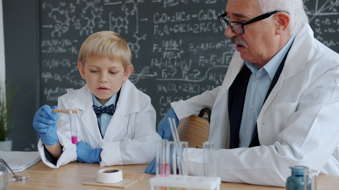 Young boy and older man in lab coats experiment