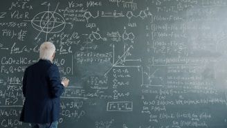 Professor writing complex formulas on a chalkboard