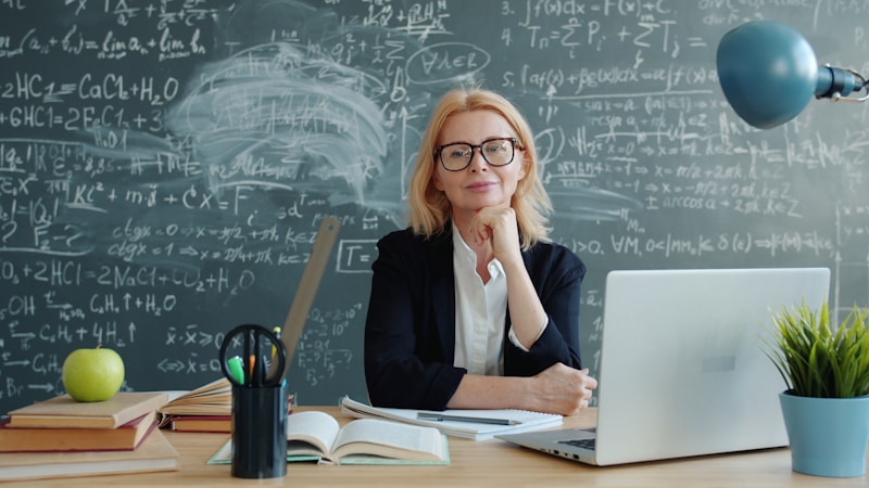 Mature woman professional at her desk with laptop