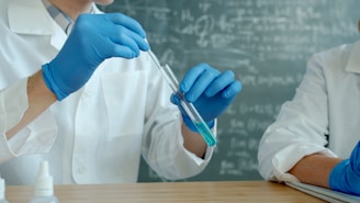Scientists in lab coats working with test tubes