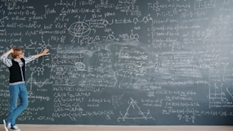 Student pointing at complex math equations on blackboard