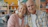 Elderly couple smiling together on a couch.