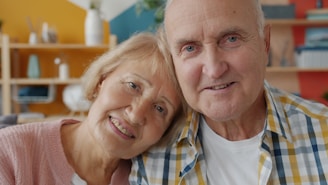 Elderly couple smiling together at home.