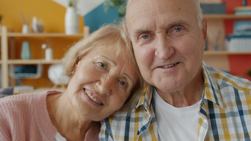 Older couple smiling together at home
