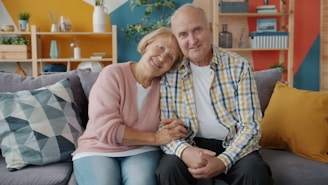 Elderly couple smiling on a couch