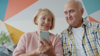 Elderly couple looking at a smartphone together on phone