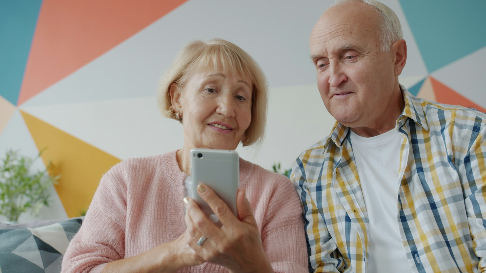 Elderly couple looking at a smartphone together on phone