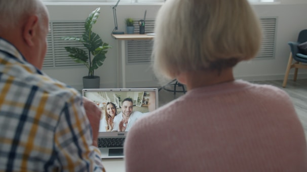 Elderly couple video calling with family at home