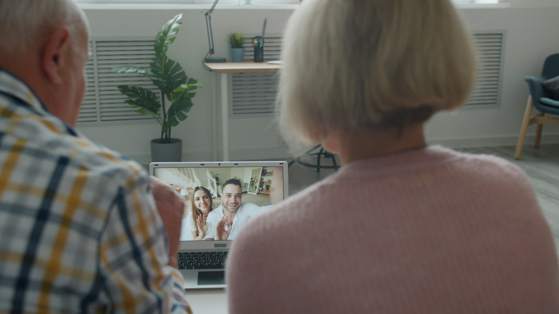 Elderly couple video calling with family at home