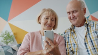 Elderly couple looking at a smartphone together