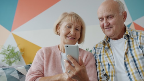 Elderly couple looking at a smartphone together