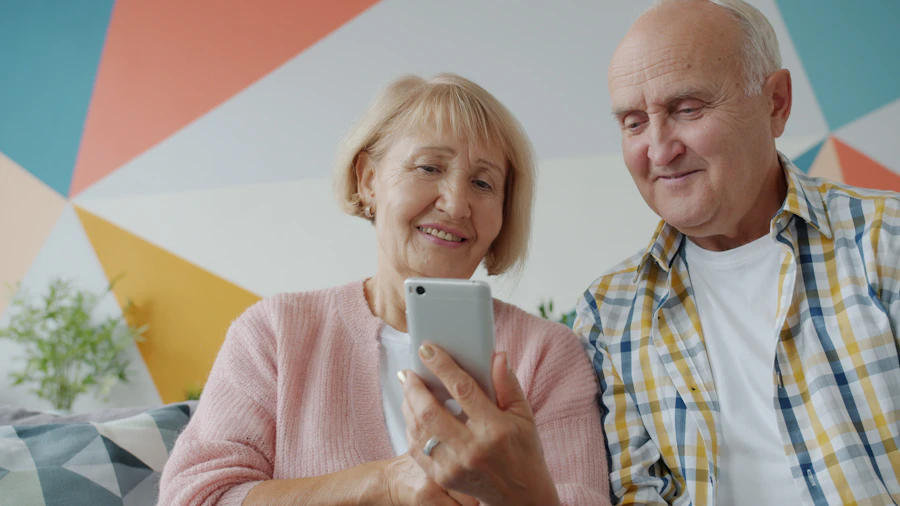 A senior couple sitting on a couch together, smiling as they read something on a phone — exactly the moment our Letter is written for.