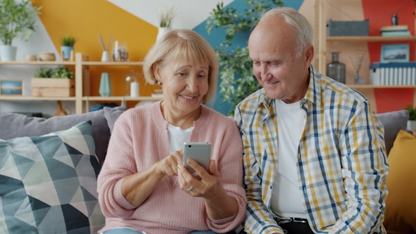 Elderly couple looking at a smartphone together