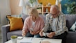 Elderly couple managing finances at home
