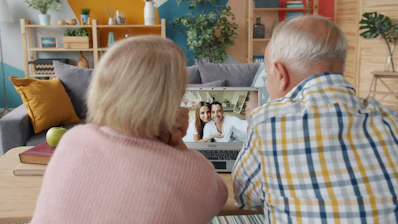 Elderly couple video calling with family at home.