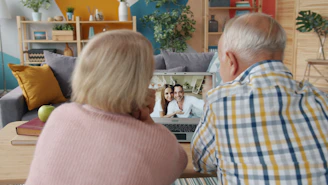Elderly couple video calling with family at home
