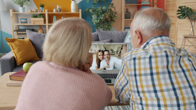 Elderly couple video calling with family at home