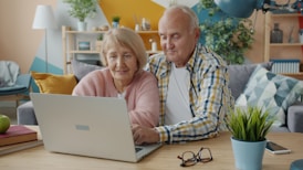 Elderly couple looking at a laptop together