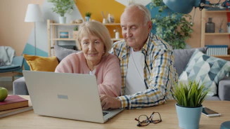 Elderly couple looking at a laptop together