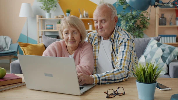 Elderly couple looking at a laptop together