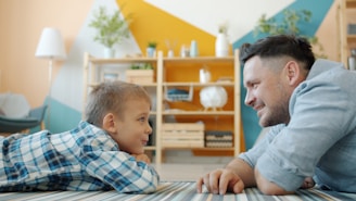 Father and son looking at each other on floor