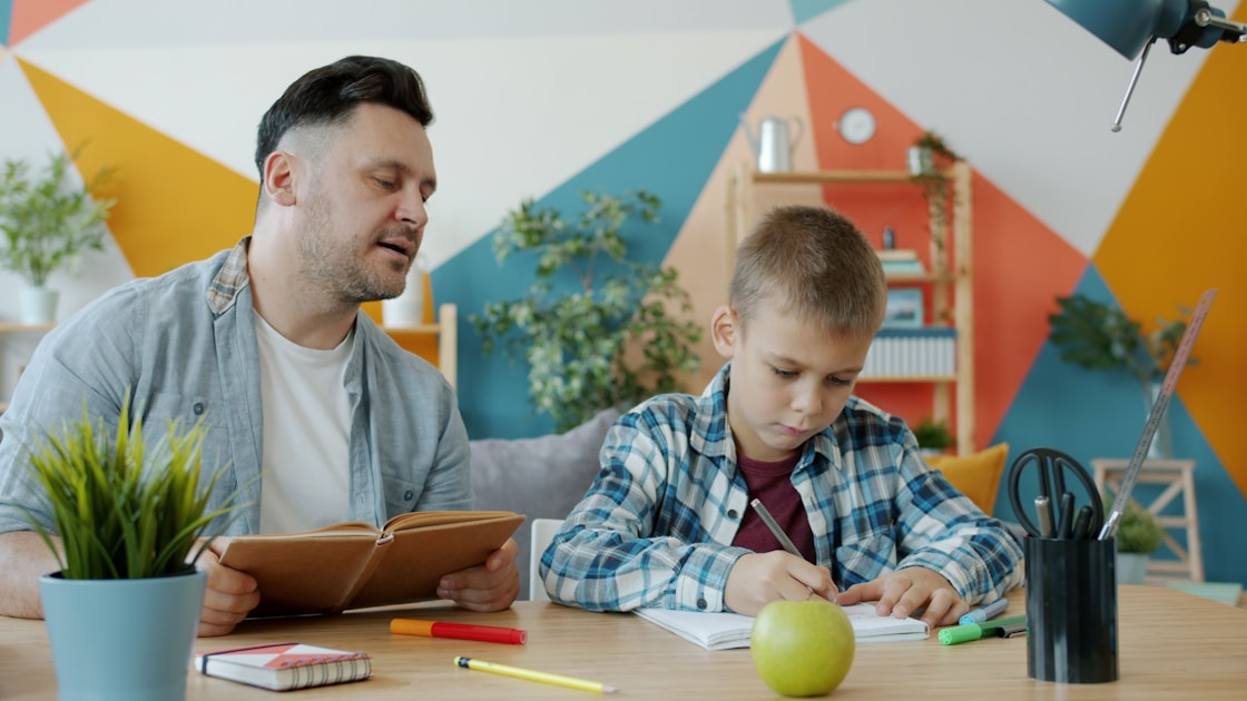 Parent helping child with tasks at desk - executive function ADHD children Sydney