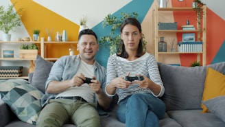 Couple playing video games on sofa