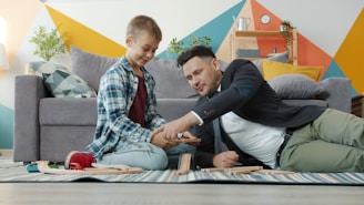 Father and son playing with wooden blocks together.