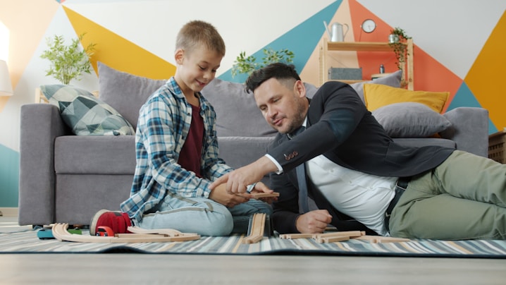 Father and son playing with wooden blocks together.