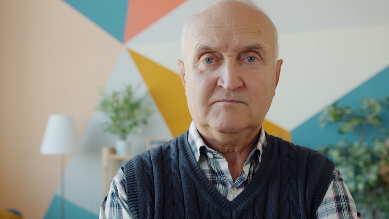 Elderly man with surprised expression indoors