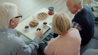 Three seniors enjoying tea and pie together