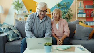 Elderly couple looking at a laptop together