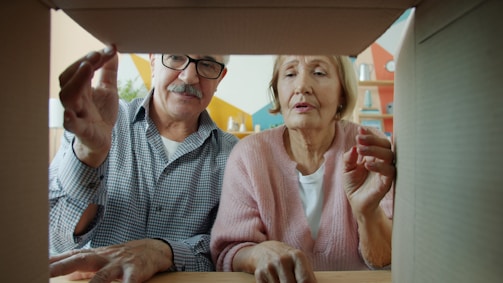 Elderly couple looking into an open cardboard box