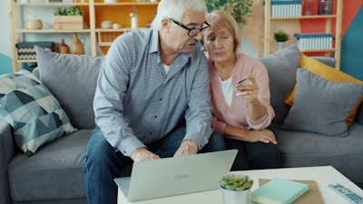 Elderly couple looking at a laptop together