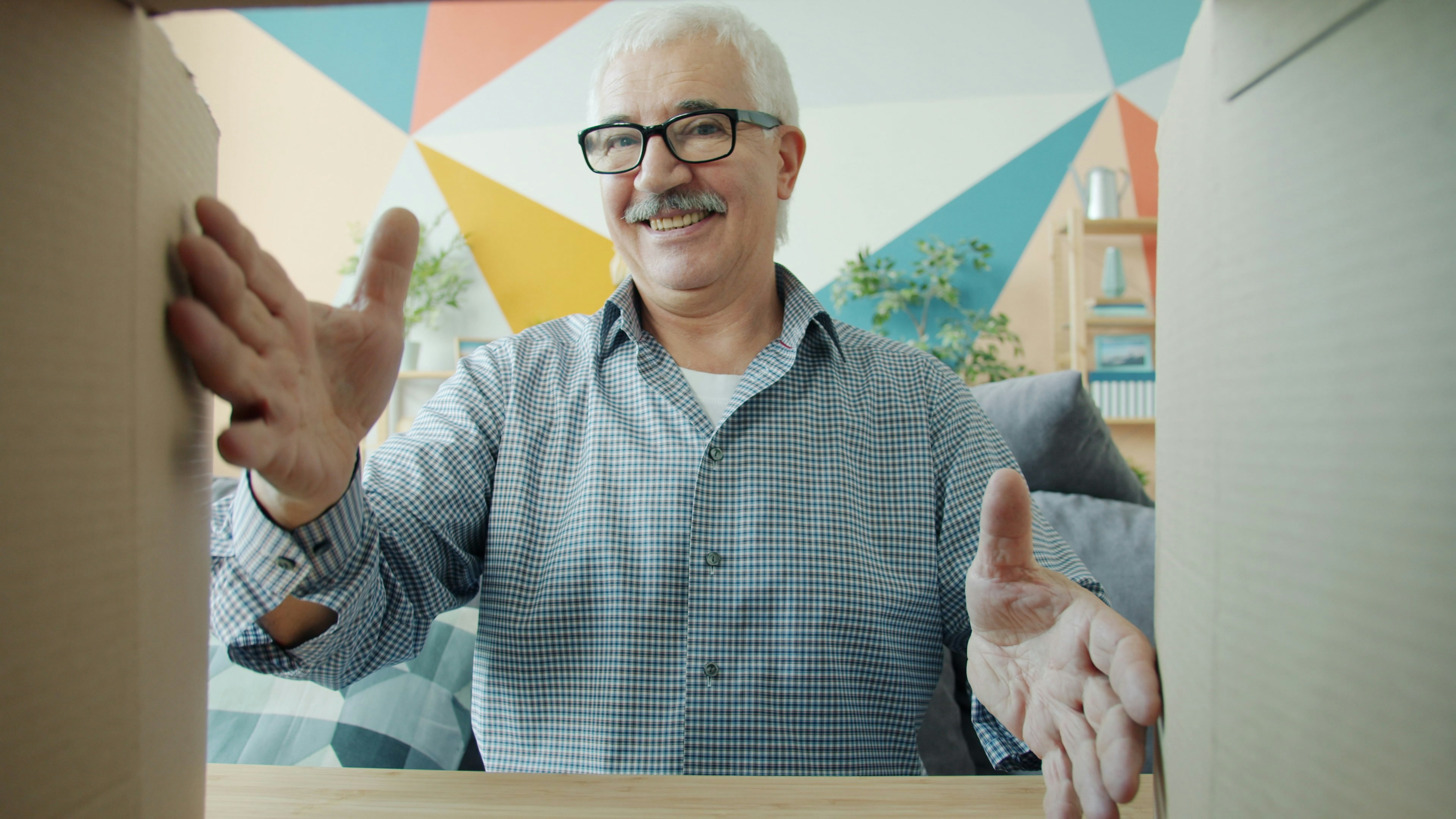 Smiling man looking into an open cardboard box