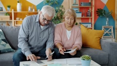 Elderly couple reviewing documents at home