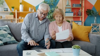Elderly couple reviewing documents at home