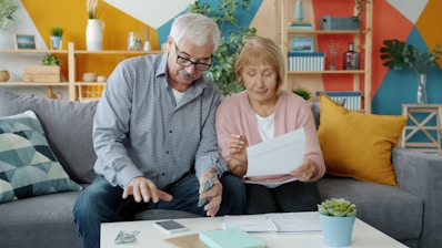 Elderly couple reviewing documents at home