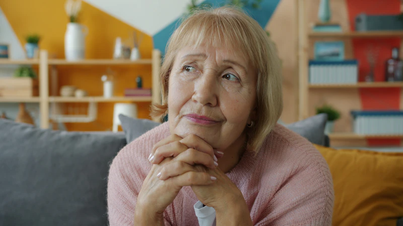 Thoughtful Filipino Sugar Mommy with clasped hands