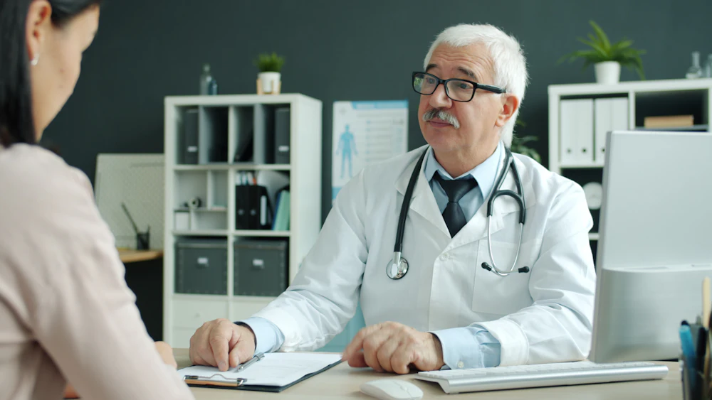 Indian doctor consulting with a patient