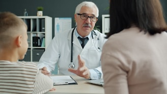 Doctor consults with mother and child in office.