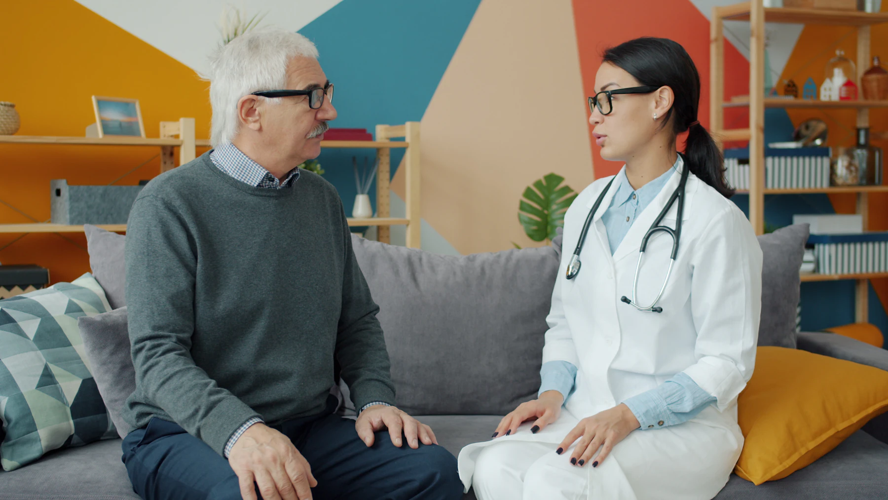Clinician speaking with an older adult while planning the next stage of recovery
