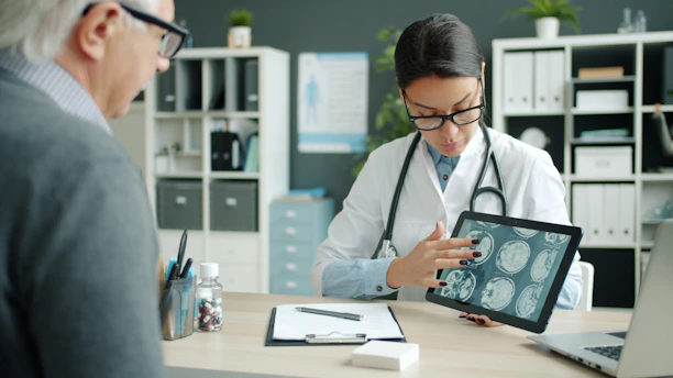 Doctor shows patient brain scans on tablet