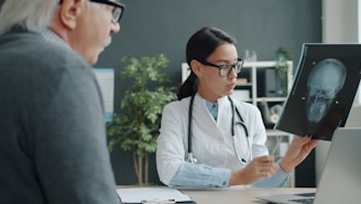 Doctor shows patient an x-ray of a skull.